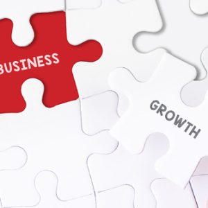 Female hand and missing puzzle with business growth
