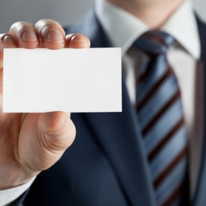 Man in suit showing blank card