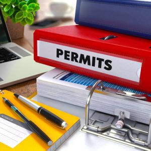 Permits in a binder, pen and note book