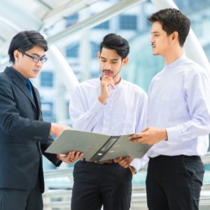 3 Male worker standing and discuss about work