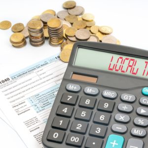 pile of coins, tax form and calculator