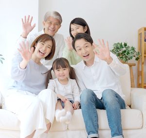Asian family waving hands