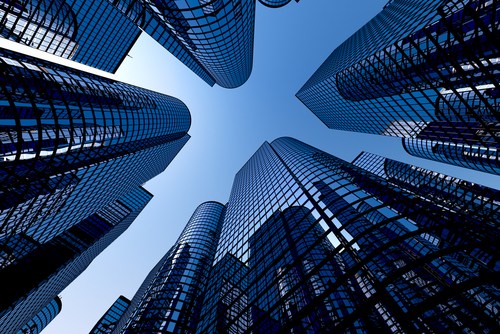 Low angle shot of modern glass city buildings with clear sky