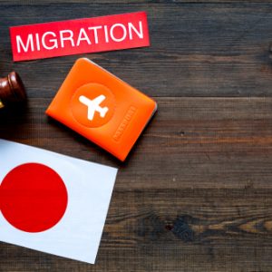 Immigration,To,Japan,Concept.,Text,Immigration,Near,Passport,Cover,And
