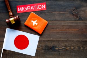 Immigration To Japan Concept. Text Immigration Near Passport Cover