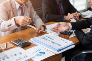 Corporate meetings, Business team organizations and investment plans at working with new startup project with chart,graph and business accessories on workplace.