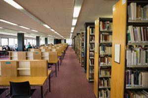 Volumes,Of,Books,On,Bookshelf,In,Library,At,The,University