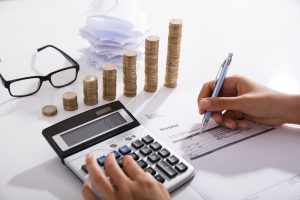Accountant,Calculating,Tax,Using,Calculator,On,Desk.,Save,Money,Concept
